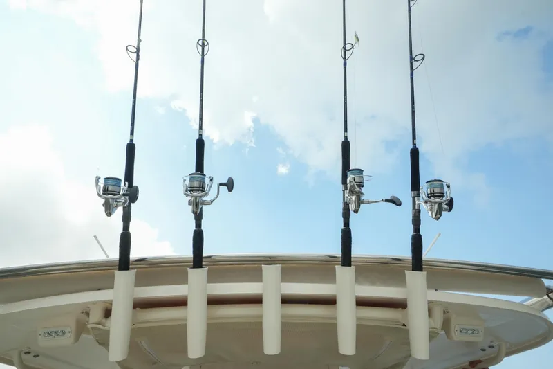 Slide: The Image of Fishing rods on a 2019 Grady-White Canyon 336 boat against a cloudy sky. - 18