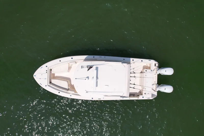 Slide: The Image of Aerial view of 2019 Grady-White Canyon 336 boat on green water. - 2