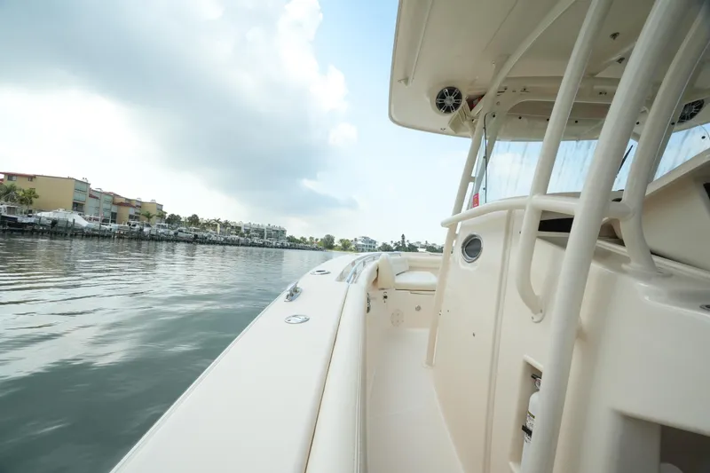 Slide: The Image of 2019 Grady-White Canyon 336 boat on calm water, side view. - 22