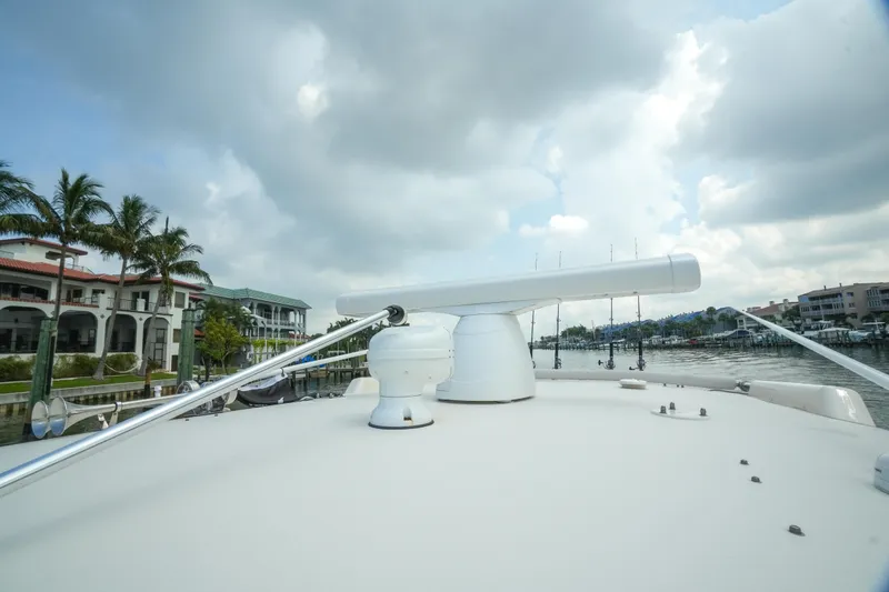 Slide: The Image of 2019 Grady-White Canyon 336 boat with radar, docked near waterfront homes. - 24
