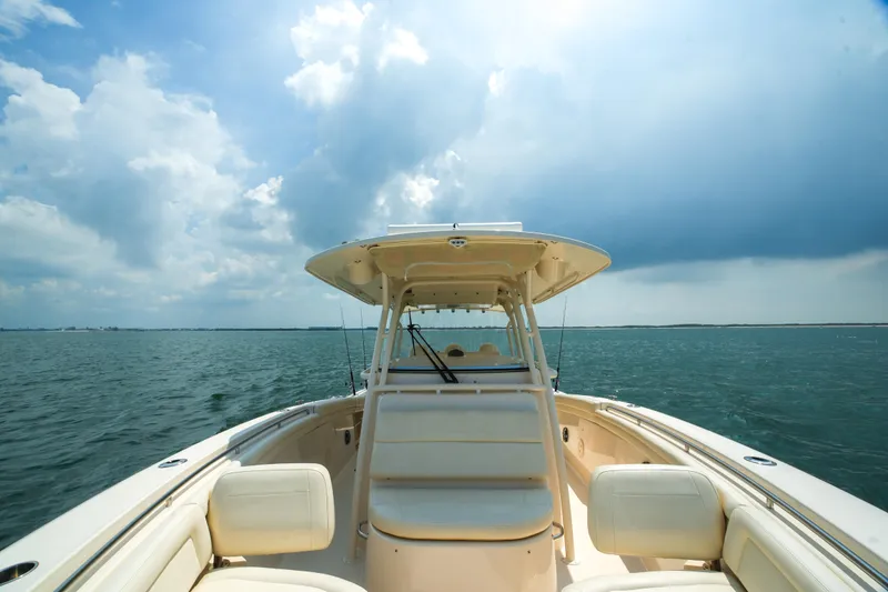 Slide: The Image of 2019 Grady-White Canyon 336 boat on open water under a cloudy sky. - 27