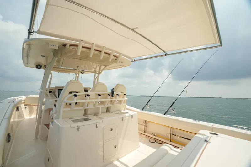 Slide: The Image of 2019 Grady-White Canyon 336 boat interior with fishing rods and ocean view. - 28