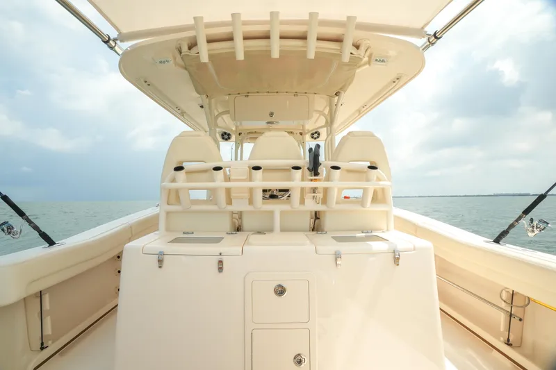 Slide: The Image of 2019 Grady-White Canyon 336 boat interior with seating and storage on open water. - 29