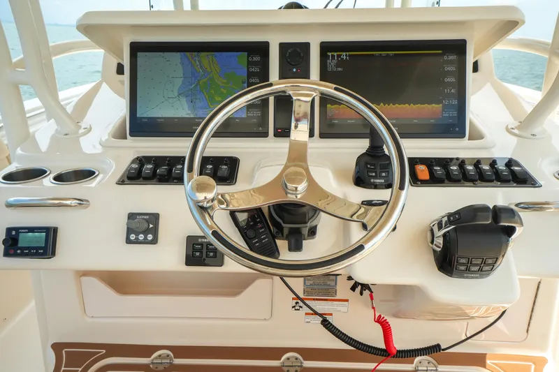 Slide: The Image of 2019 Grady-White Canyon 336 helm with dual navigation screens and steering wheel. - 31