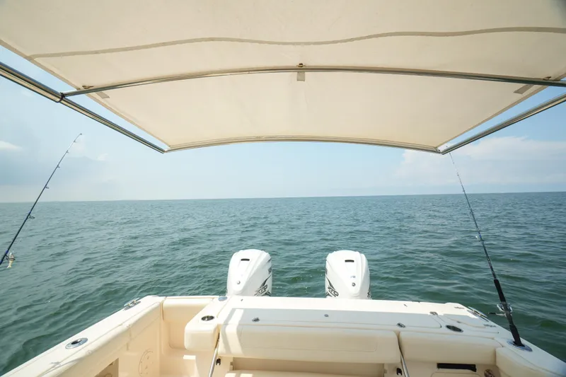 Slide: The Image of 2019 Grady-White Canyon 336 boat with fishing rods, ocean view, and canopy. - 33