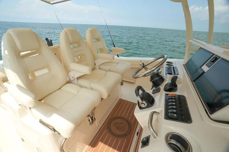 Slide: The Image of 2019 Grady-White Canyon 336 boat interior with luxurious seating and advanced controls. - 34