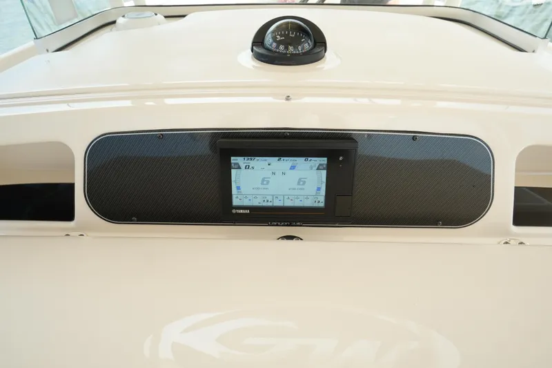 Slide: The Image of 2019 Grady-White Canyon 336 dashboard with navigation display and compass. - 35