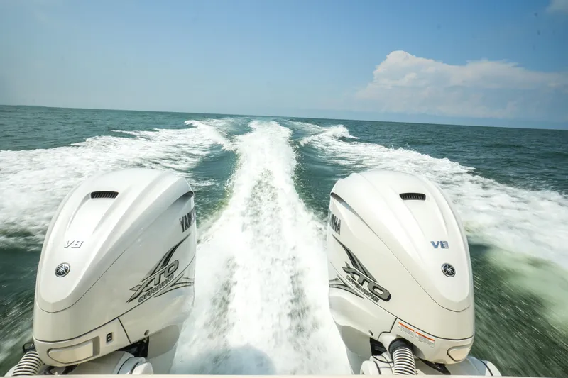 Slide: The Image of 2019 Grady-White Canyon 336 boat with twin outboard engines on open water. - 40