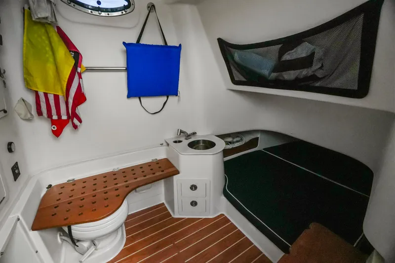 Slide: The Image of 2019 Grady-White Canyon 336 cabin interior with seating, sink, and nautical decor. - 41