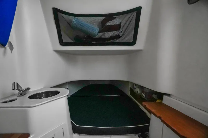 Slide: The Image of 2019 Grady-White Canyon 336 cabin interior with bed, sink, and storage. - 42