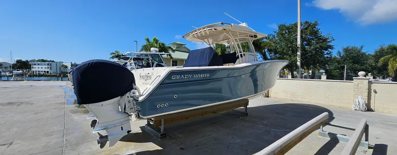 Slide: The Image of 2019 Grady-White Canyon 336 boat on a dock under clear blue sky. - 45