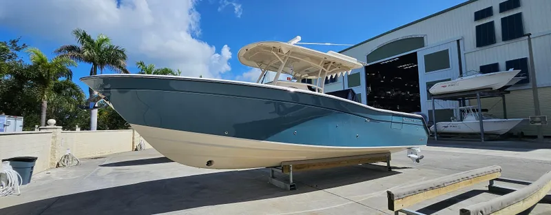 Slide: The Image of 2019 Grady-White Canyon 336 boat displayed outdoors near a large building. - 46
