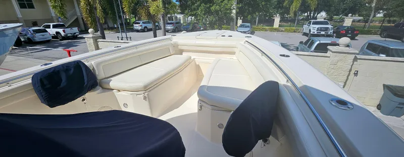 Slide: The Image of 2019 Grady-White Canyon 336 boat interior with cushioned seating and covered chairs. - 48