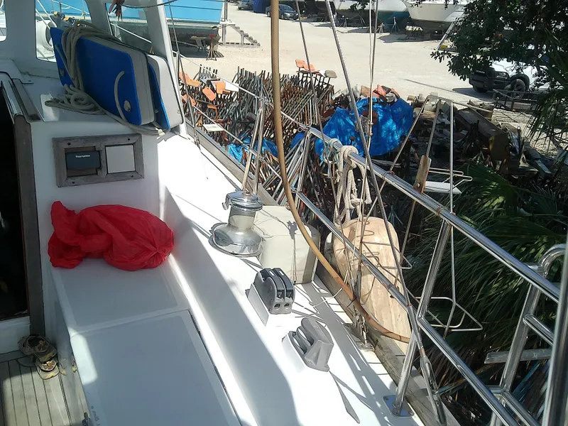 Slide: The Image of 1971 Morgan 40 Cruising Ketch deck with winch, ropes, and equipment in a marina setting. - 11