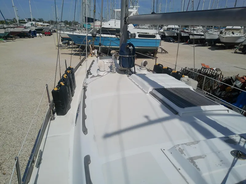 Slide: The Image of 1971 Morgan 40 Cruising Ketch on dry dock, surrounded by other boats. - 14
