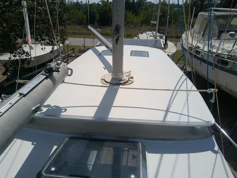 Slide: The Image of 1971 Morgan 40 Cruising Ketch sailboat deck view, docked with surrounding boats. - 23