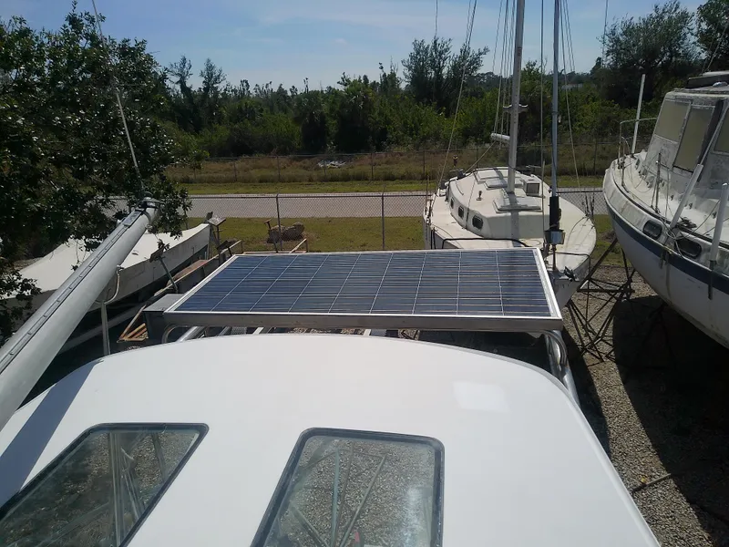 Slide: The Image of 1971 Morgan 40 Cruising Ketch with solar panel, docked among other boats. - 27