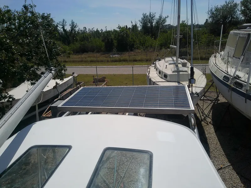 Slide: The Image of 1971 Morgan 40 Cruising Ketch with solar panel, docked among other boats. - 28