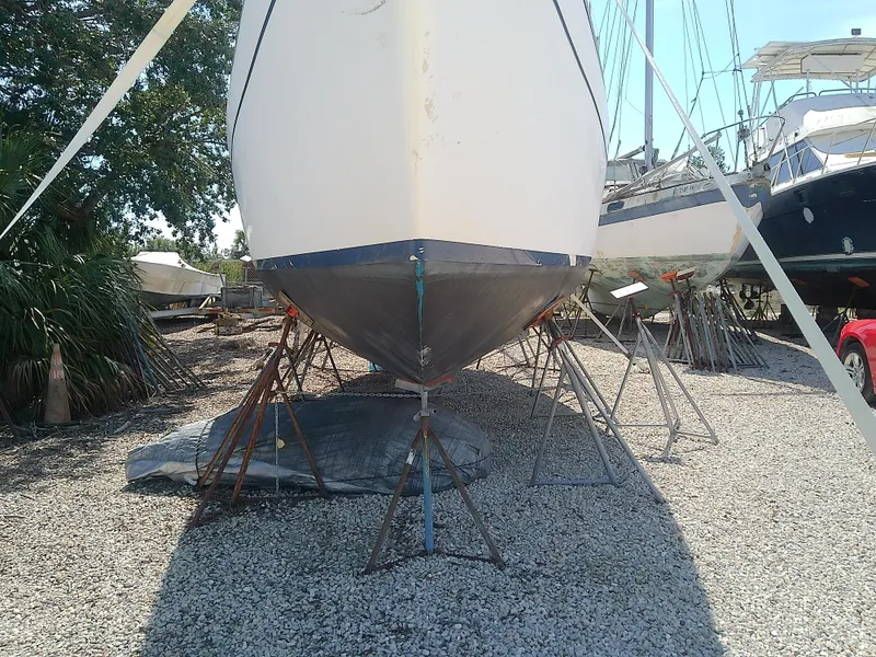 Slide: The Image of 1971 Morgan 40 Cruising Ketch on stands, displayed outdoors on gravel. - 4