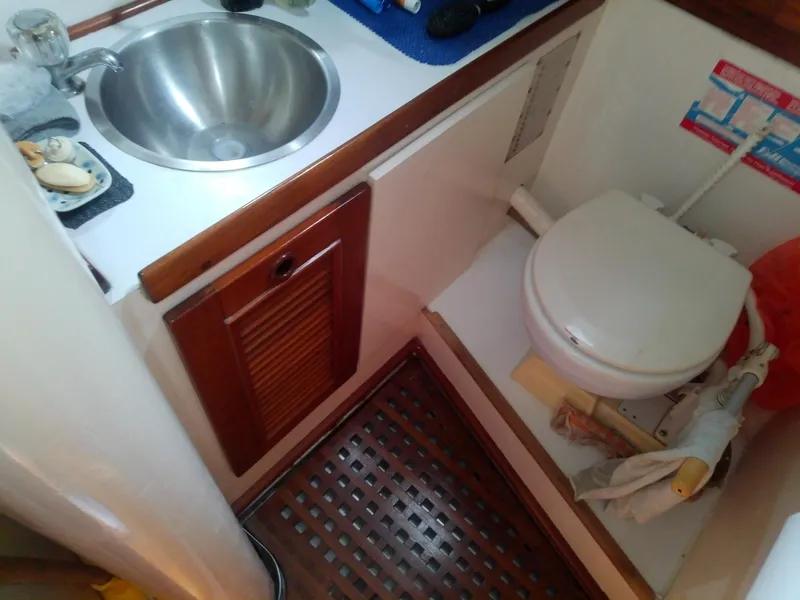 Slide: The Image of 1971 Morgan 40 Cruising Ketch bathroom with sink and toilet, featuring wooden accents. - 41