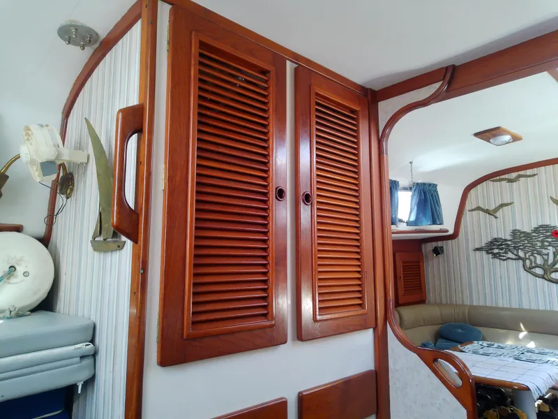 Slide: The Image of Interior of 1971 Morgan 40 Cruising Ketch with wooden cabinets and nautical decor. - 47
