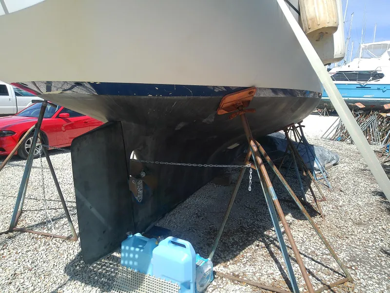 Slide: The Image of 1971 Morgan 40 Cruising Ketch on stands, showing hull and rudder in a boatyard. - 7
