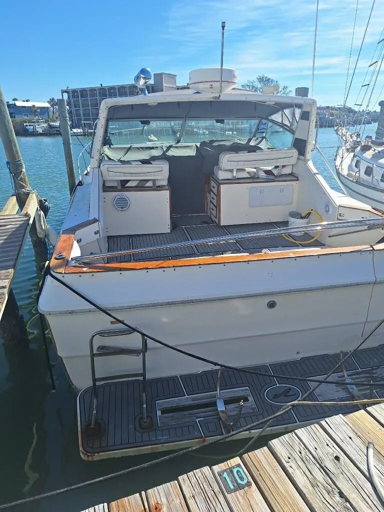 Slide: The Image of 1985 Sea Ray 390 Express Cruiser docked at marina, rear view. - 1