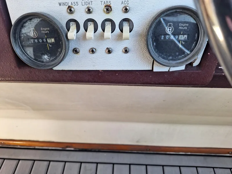 Slide: The Image of Control panel of 1985 Sea Ray 390 Express Cruiser showing engine hours and switches. - 10