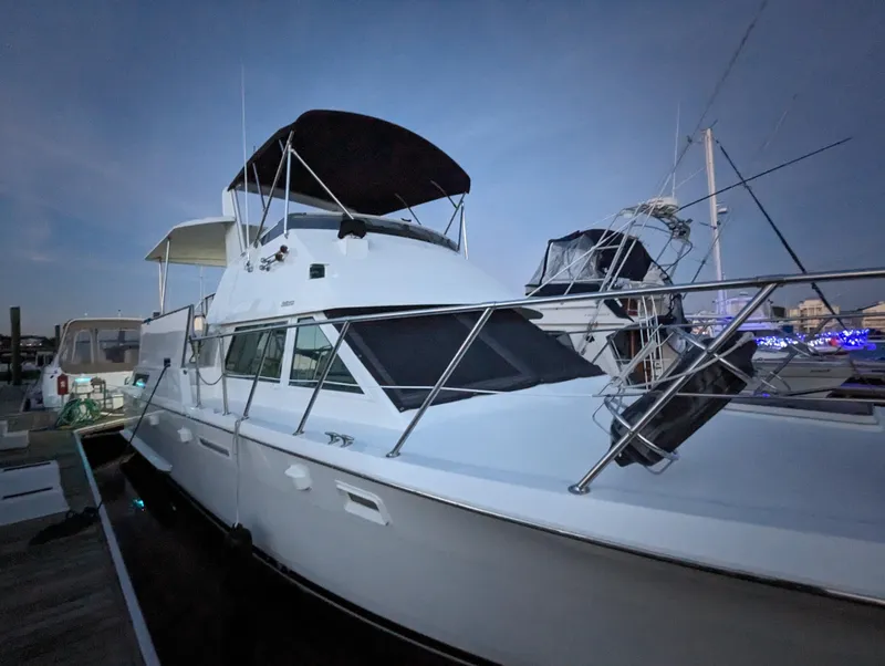 Slide: The Image of 1996 Hatteras 42 Cockpit MY yacht docked at marina during twilight. - 1