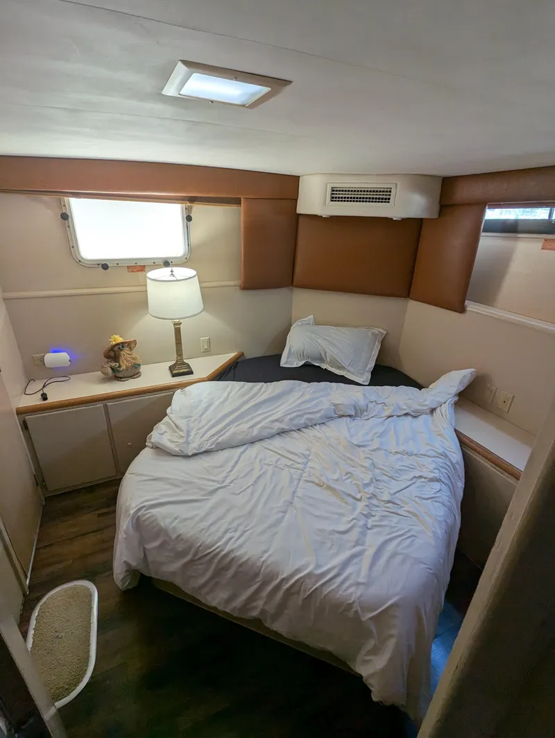 Slide: The Image of Cozy bedroom interior of 1996 Hatteras 42 Cockpit MY yacht with bed and lamp. - 14