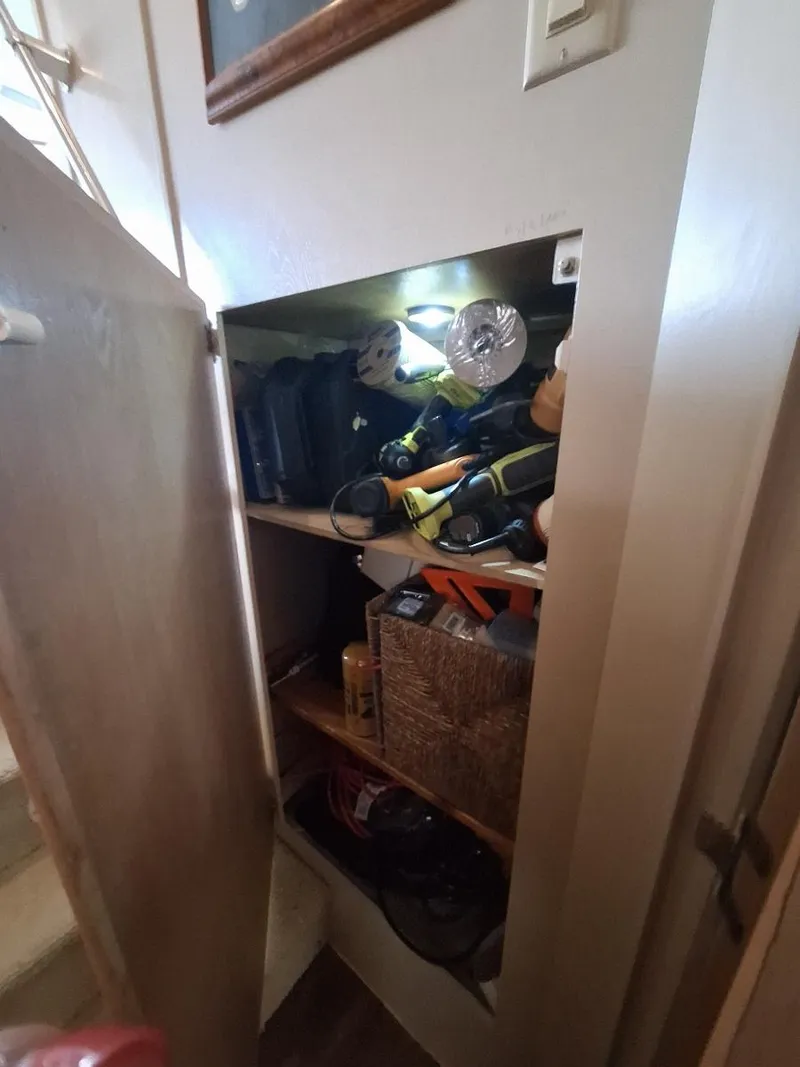 Slide: The Image of Storage cabinet with tools and supplies on a 1996 Hatteras 42 Cockpit MY boat. - 28