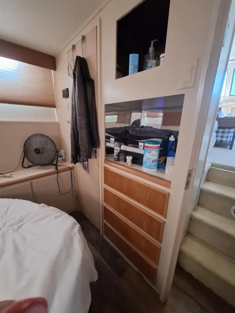 Slide: The Image of Interior of 1996 Hatteras 42 Cockpit MY with storage, fan, and stairs. - 29