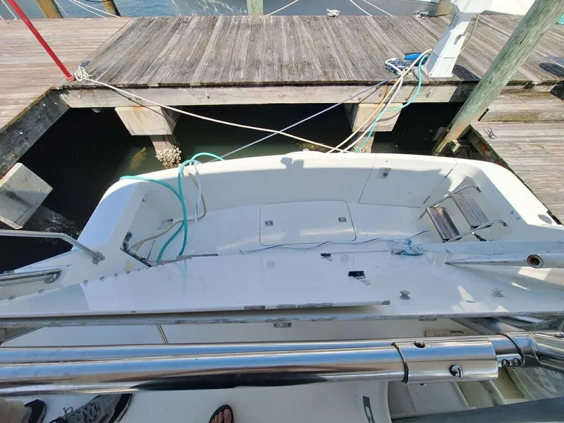 Slide: The Image of 1996 Hatteras 42 Cockpit MY at dock, showing spacious cockpit and mooring lines. - 38