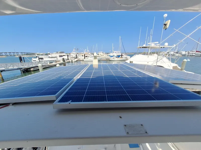 Slide: The Image of Solar panels on a 1996 Hatteras 42 Cockpit MY yacht at a marina. - 44