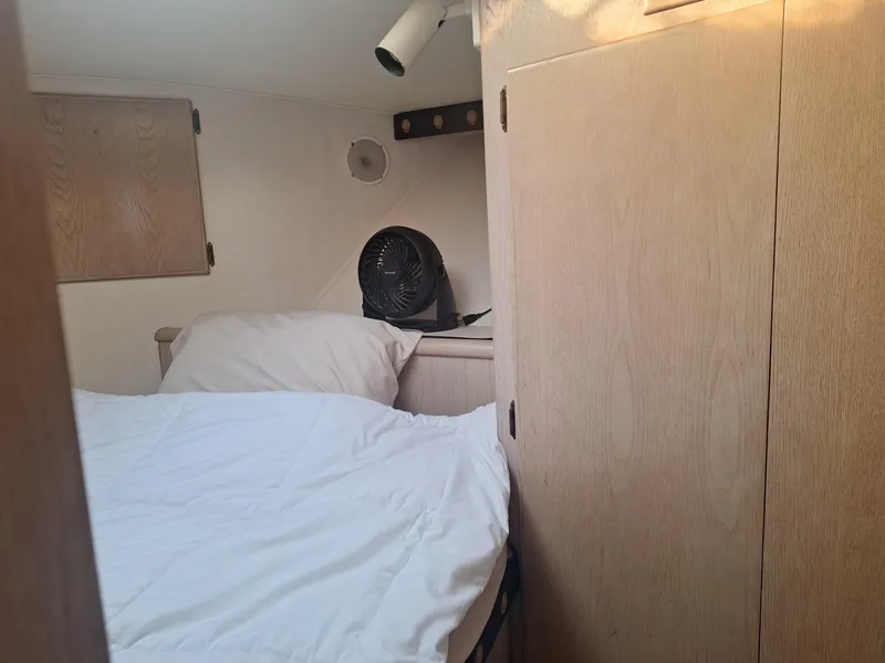 Slide: The Image of Cozy cabin interior of 1996 Hatteras 42 Cockpit MY with bed and fan. - 49