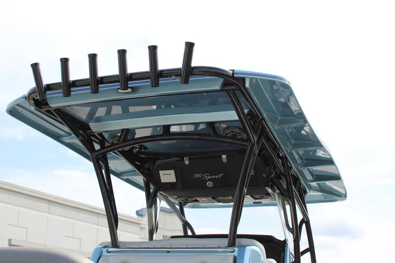 Slide: The Image of 2021 Nor-Tech 390 Sport Center Console boat with sleek T-top design and rod holders. - 22