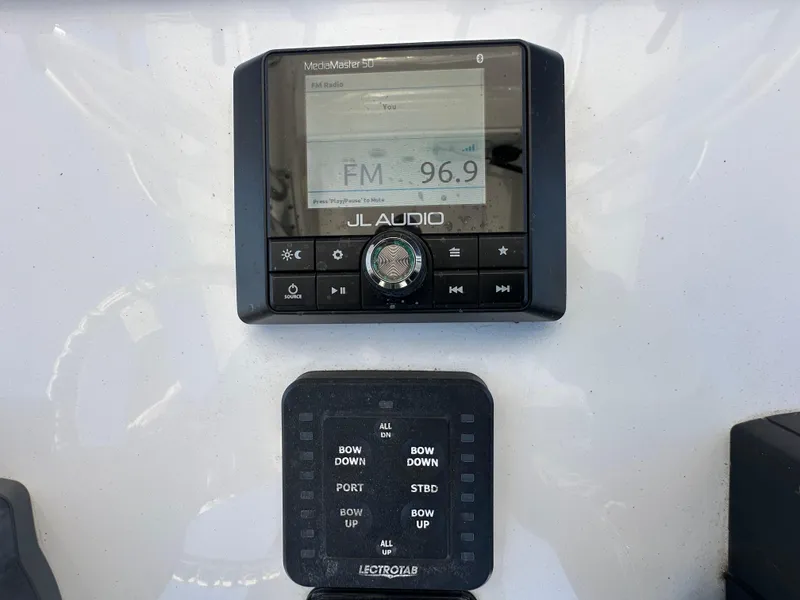 Slide: The Image of JL Audio system and control panel on 2021 Sportsman Masters 247 Bay Boat. - 16