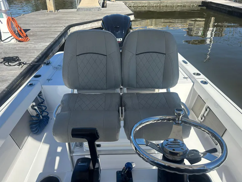 Slide: The Image of 2021 Sportsman Masters 247 Bay Boat interior with dual seats and steering wheel. - 18