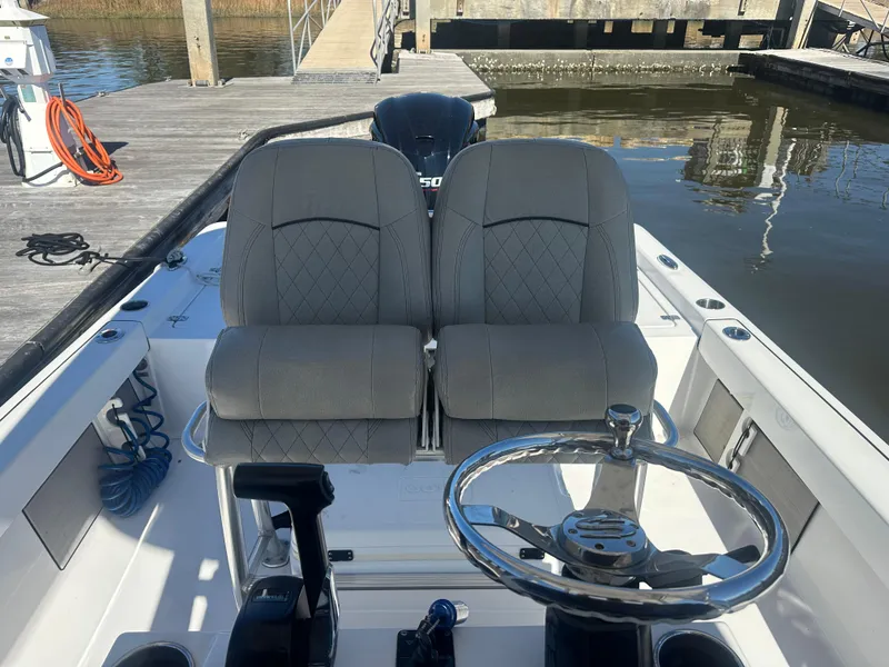 Slide: The Image of 2021 Sportsman Masters 247 Bay Boat interior with dual seats and steering wheel. - 19