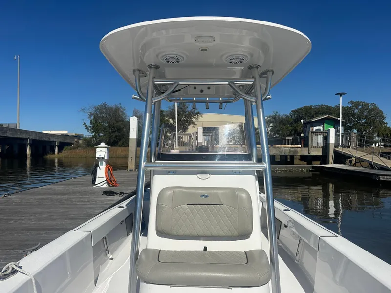 Slide: The Image of 2021 Sportsman Masters 247 Bay Boat docked at a marina under clear blue skies. - 21