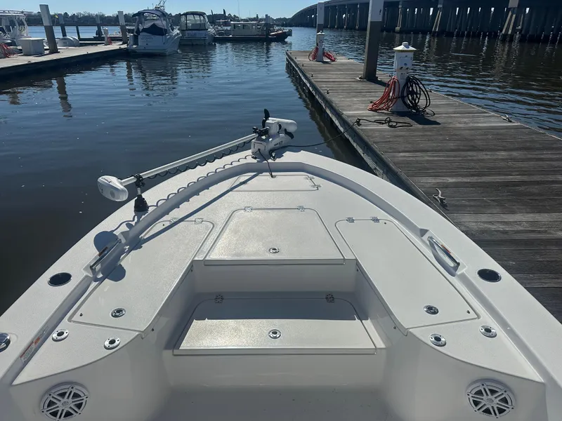 Slide: The Image of 2021 Sportsman Masters 247 Bay Boat docked at marina, featuring spacious deck and modern design. - 22
