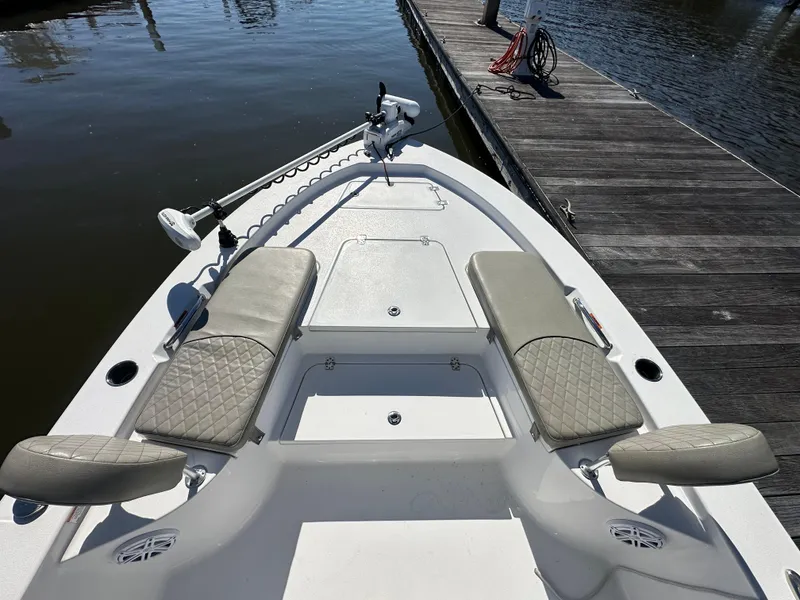 Slide: The Image of 2021 Sportsman Masters 247 Bay Boat with cushioned seating, docked by wooden pier. - 23