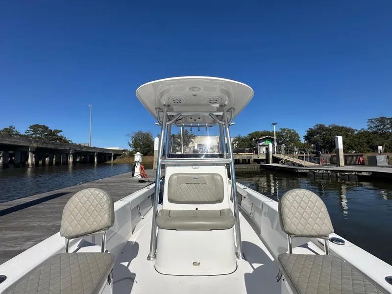 Slide: The Image of 2021 Sportsman Masters 247 Bay Boat docked, featuring spacious seating and sleek design. - 24