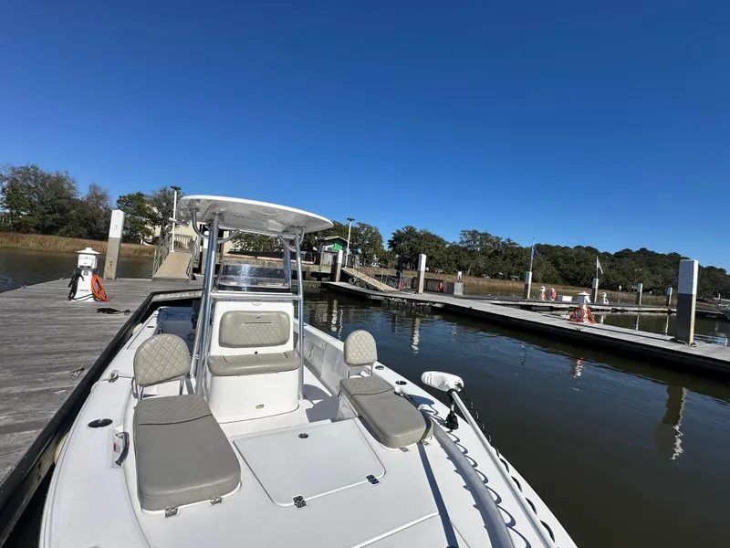 Slide: The Image of 2021 Sportsman Masters 247 Bay Boat docked at a marina under clear blue skies. - 25