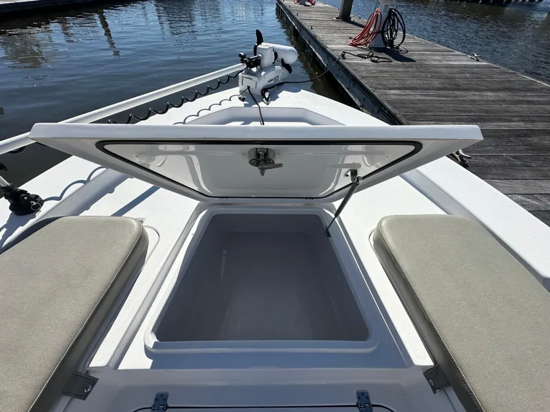 Slide: The Image of 2021 Sportsman Masters 247 Bay Boat with open storage compartment at dock. - 28
