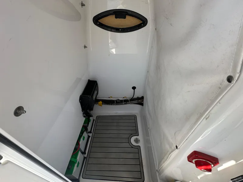 Slide: The Image of 2021 Sportsman Masters 247 Bay Boat interior compartment with equipment and storage space. - 31