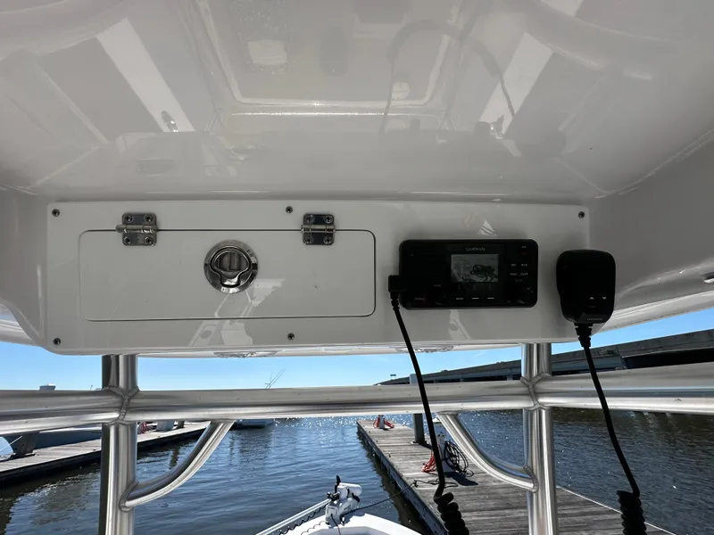 Slide: The Image of 2021 Sportsman Masters 247 Bay Boat console with electronics, dock view in background. - 32