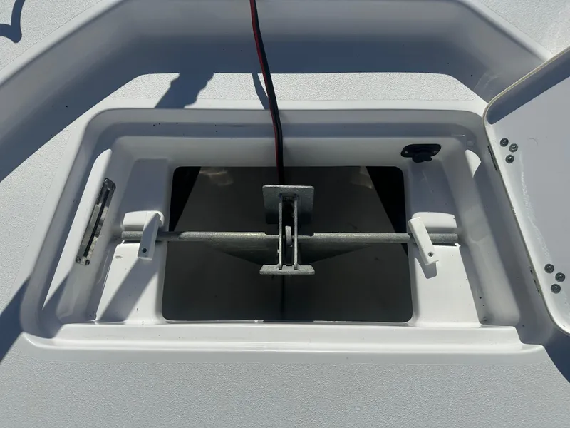 Slide: The Image of Anchor compartment of 2021 Sportsman Masters 247 Bay Boat, open lid view. - 35