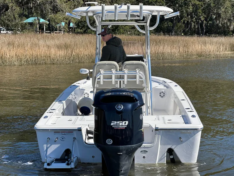 Slide: The Image of 2021 Sportsman Masters 247 Bay Boat on water, rear view with outboard motor. - 4