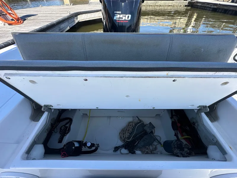 Slide: The Image of Open storage compartment on 2021 Sportsman Masters 247 Bay Boat, showing gear and equipment. - 40